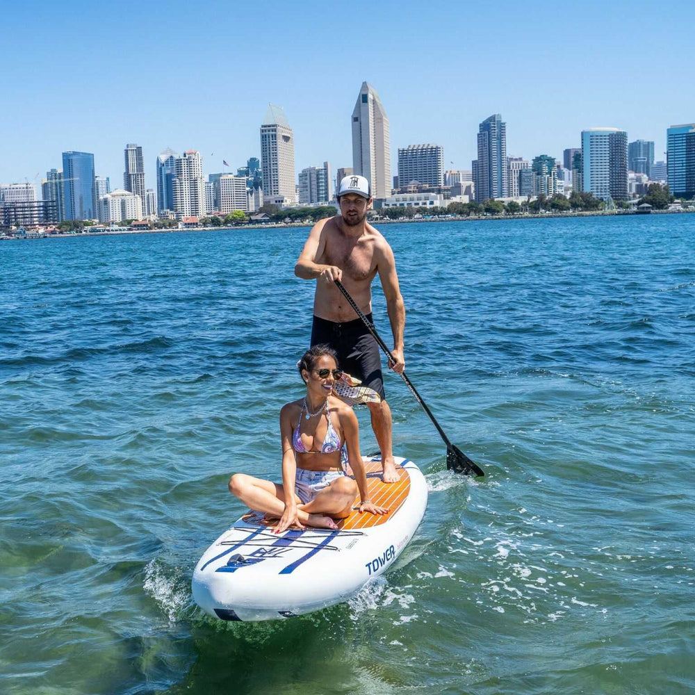 Man and woman paddling a Tower X-Class board together