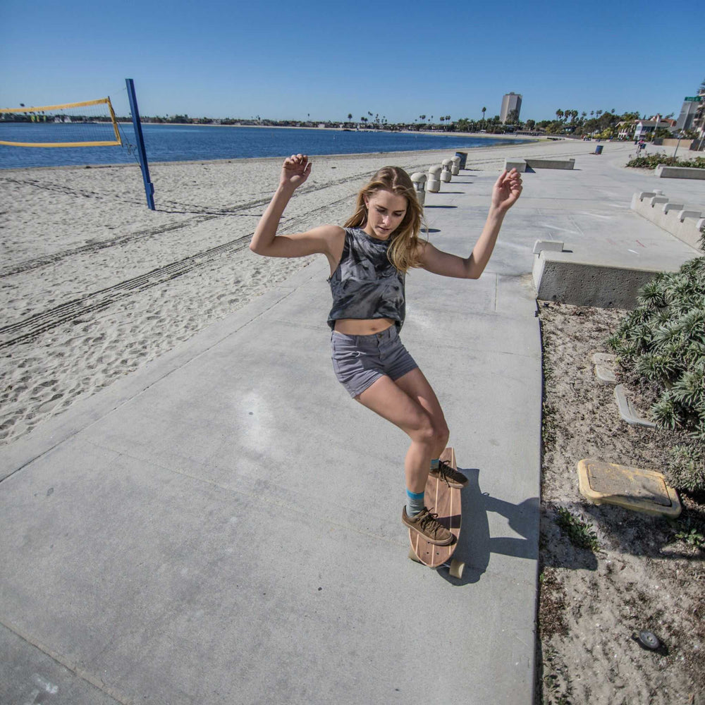 Woman carving with a Mini cruiser skateboard from Tower