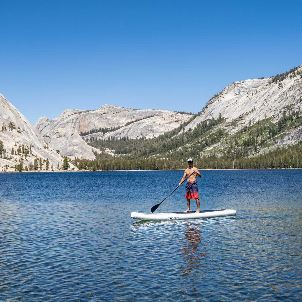 man on Tower paddle board in mountain lake