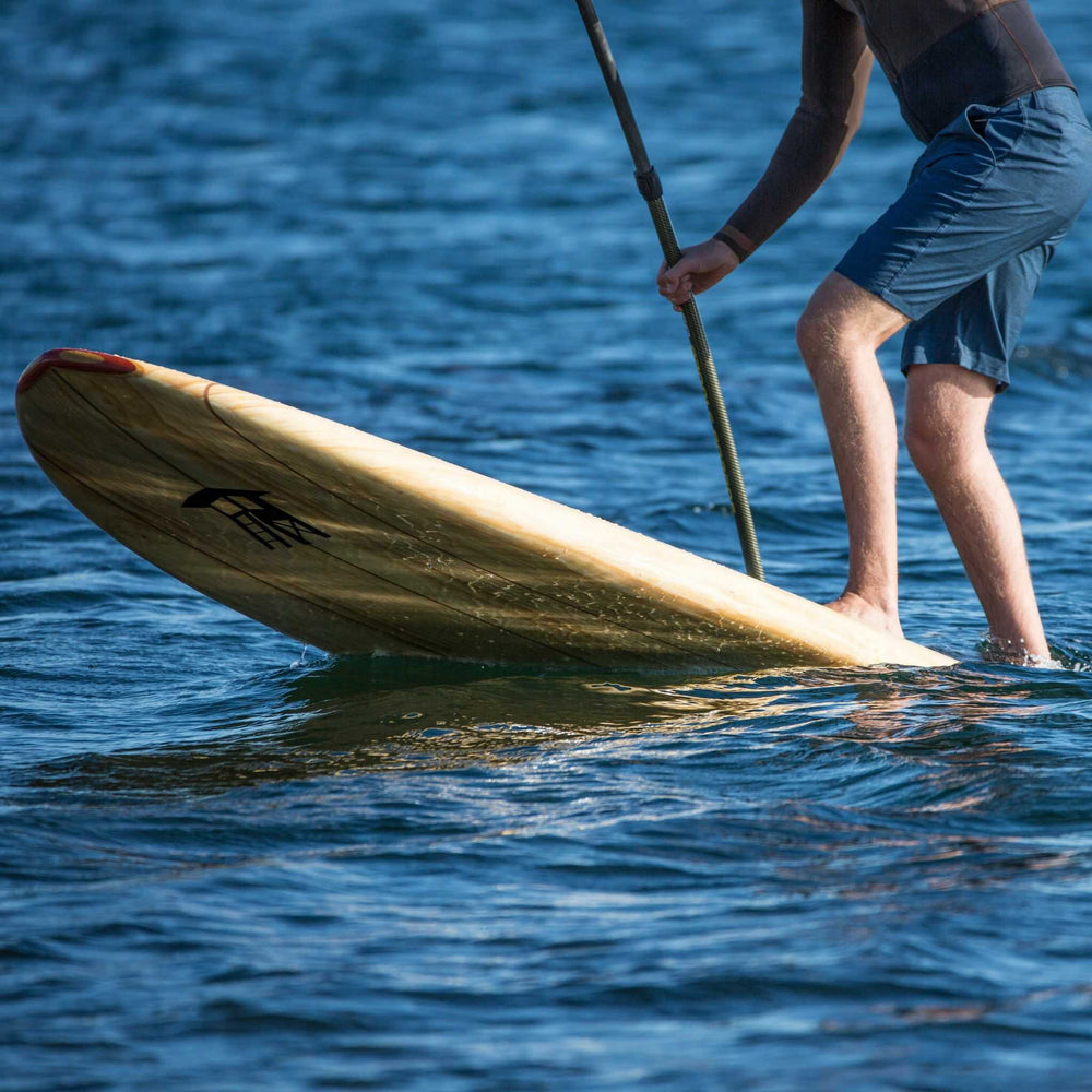 Tower wood paddle board raised out of the water