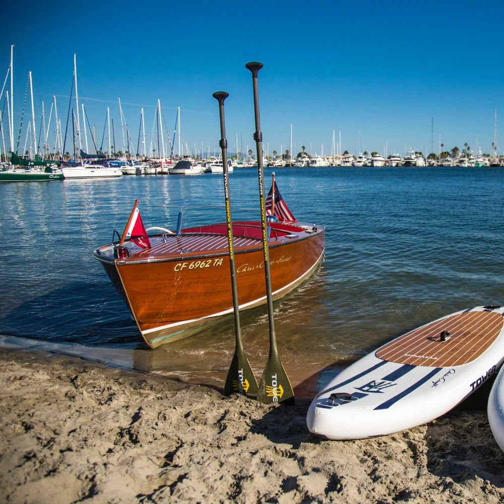 carbon kevlar paddles in between Chris craft boat and Tower iSUP