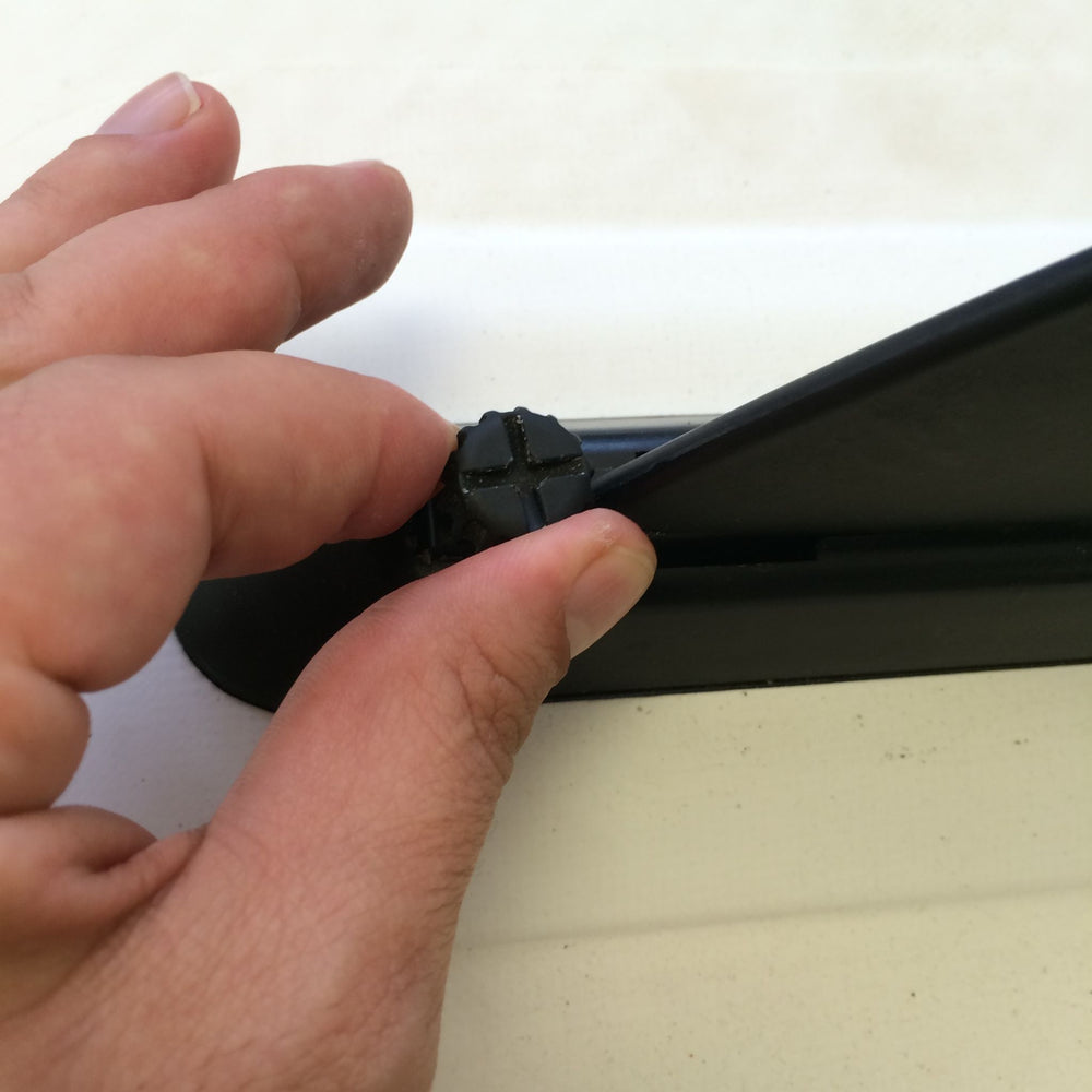 Tool free paddle board fin being tightened in place by hand