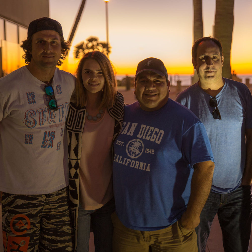 Group of people wearing Tower blue flex fit hat