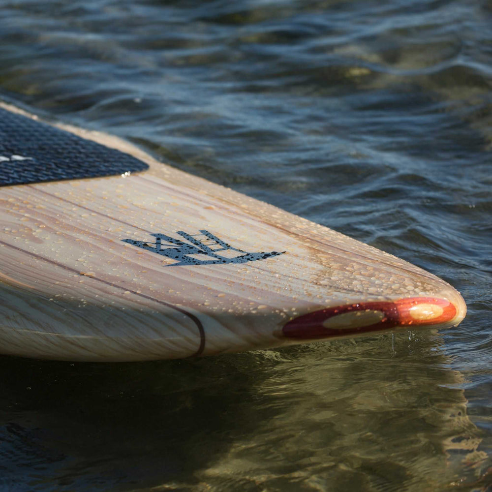 Tower wood paddle board nose in the water