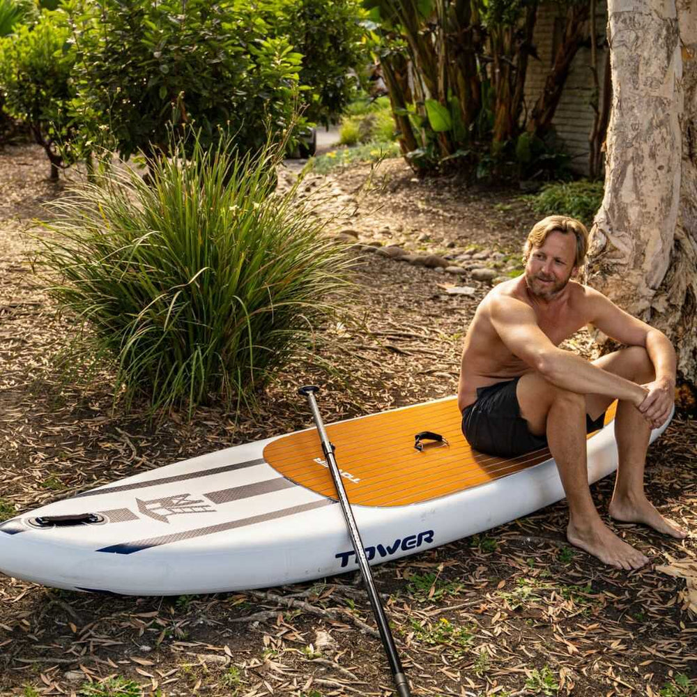 Man sitting on a Tower paddle board