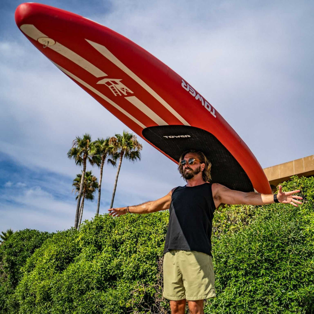 Man balancing Tower iRace paddle board on his head