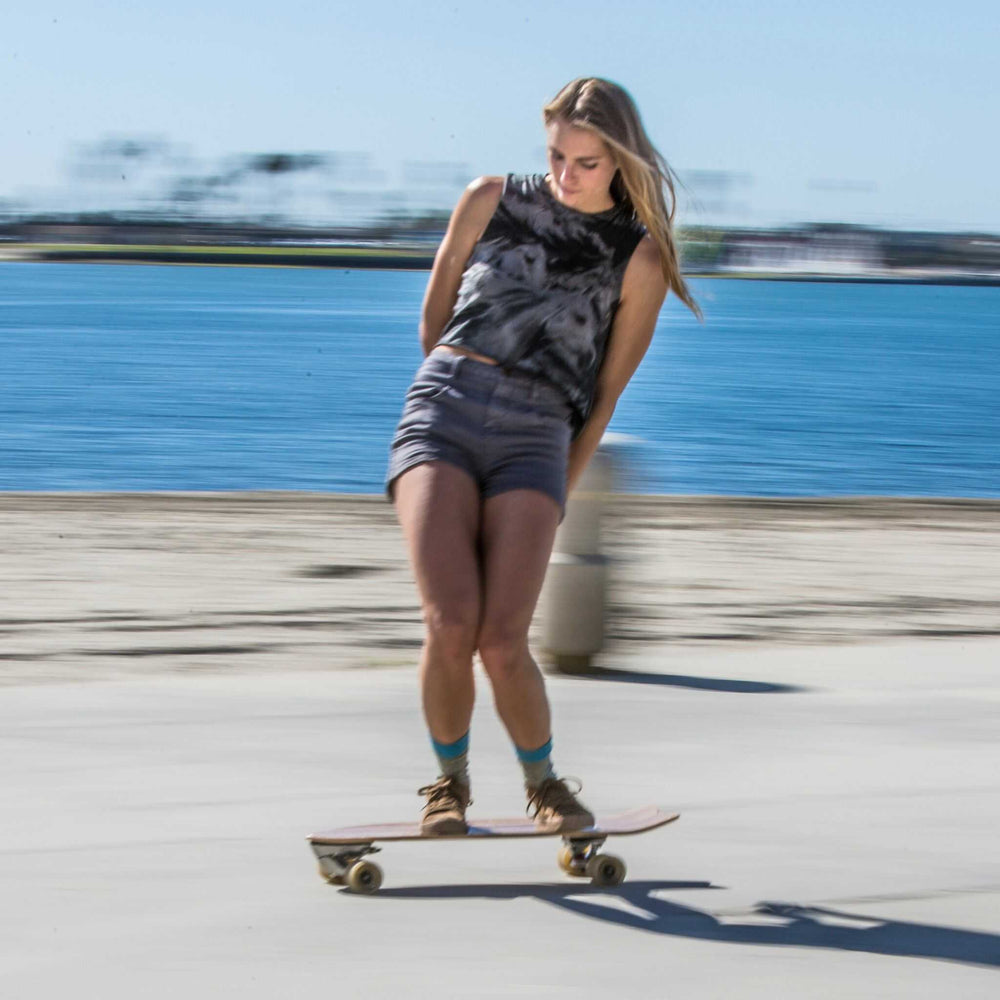 Woman riding a mini cruiser skateboard from Tower