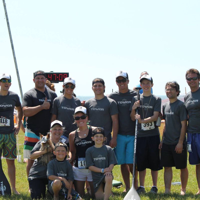 Group of people all wearing Tower paddle boards shirts